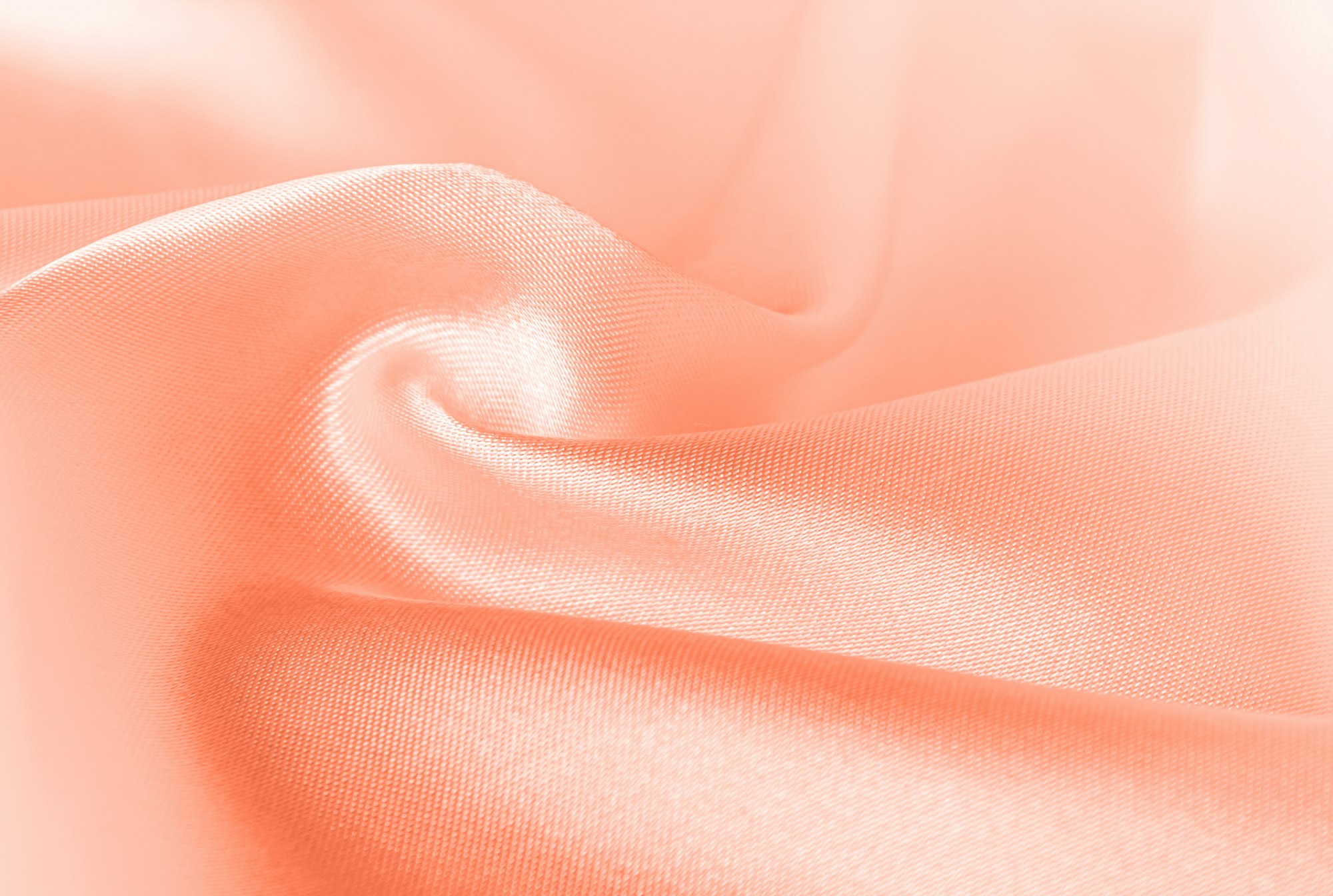 Color of the year 2024 Peach Fuzz 13-1023. Peach fuzz color silk texture, background.